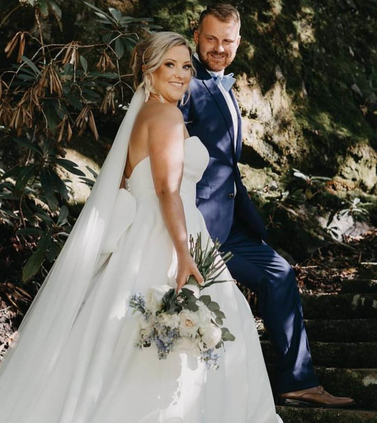 Сouple wearing a white gown and a blue suit