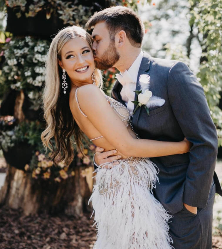 Сouple wearing a white gown and a black suit